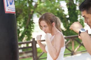 man and woman doing boxing training